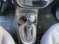 Close-up of the gear shift of a 2015 Fiat 500L showing the shift knob with P R N D and plus minus symbols for manual shifting