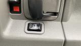 Close-up of a window control button on the armrest of a 2017 Chevrolet Express Quigley 4x4