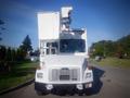 A white 2006 Freightliner FS65 equipped with an elevated work platform and safety lights on the front cab