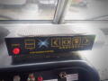 A control panel for a vehicle featuring buttons labeled for power enable and various warning systems