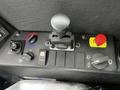 Close-up of the control panel of a 2023 Prinoth Panther T6 featuring various buttons switches and a joystick for vehicle operation