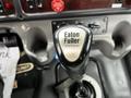 A close-up of an Eaton Fuller transmission gear shift knob inside a 2006 Freightliner M2 112 truck cabin