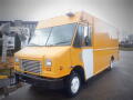 A yellow 2008 Freightliner MT45 Chassis with a white stripe on the side and a large windshield distinct front grille and side mirrors