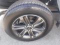 A close-up of a 2022 Ford F-150 wheel displaying a dark alloy rim mounted on a Hankook tire