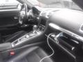 Interior of a 2016 Porsche Boxster featuring a sleek dashboard leather seats and a central console with a gear shifter and infotainment screen