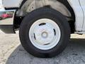 A close-up view of a white 2019 Ford Econoline wheel featuring a steel rim and a black tire with visible tread patterns