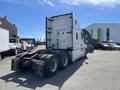 A 2022 Freightliner Cascadia truck with a rear view featuring dual tires and a white cab design
