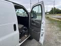 A 2014 GMC Savana van with the driver's side door open revealing the interior seat and dashboard