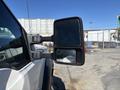 A side view mirror of a 2016 Ford F-550 with two reflective surfaces mounted on a black housing