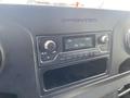 Dashboard of a 2024 Mercedes-Benz Sprinter featuring a radio display with FM settings and buttons for media control and settings
