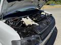 A 2017 Chevrolet Express with the hood open revealing the engine compartment and various engine components