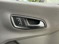 Close-up of the door handle and lock buttons on the interior of a 2022 Ford Transit vehicle