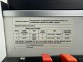 A label on a bus detailing manufacturing information including weight capacities, tire specifications, and safety compliance details