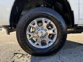 A close-up of a chrome wheel and tire from a 2023 RAM 3500 showing detailed patterns on the rim and tread of the tire