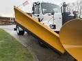 A white 2016 Freightliner 108SD truck with a yellow snow plow attachment at the front