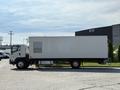 A 2024 Isuzu FVR truck with a large white cargo box and a side vent, positioned in profile with visible wheels and door handles