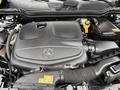 The engine cover of a 2016 Mercedes-Benz GLA-250 with the Mercedes-Benz logo prominently displayed in the center and various components visible around it