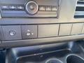 Dashboard controls of a 2012 GMC Savana featuring radio buttons and climate control knobs