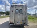 A 2007 Morgan Olson Workhorse W42 vehicle viewed from the rear featuring a silver exterior with a ladder and various lights attached
