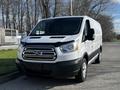 A 2017 Ford Transit van in white with a black grille and front bumper parked with the driver's side facing the viewer