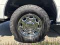 Close-up of a chrome wheel with an all-terrain tire from a 2016 Ford F-150 showcasing intricate rim design and tread pattern