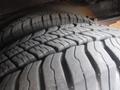 Close-up of the tread patterns on two large tires of a 2016 Chevrolet Express