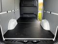 Interior of a 2022 Mercedes-Benz Sprinter with a spacious empty cargo area featuring a flat black floor and sidewalls