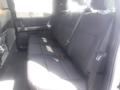 Interior view of the backseat of a 2022 Ford F-150 with a spacious bench seat featuring seat belts and a dark fabric finish