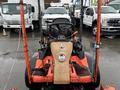 A 2012 Kubota F3680 lawn mower with a black seat and controls, featuring bright orange frame and attachments on the front