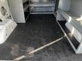 Interior of a 2017 Ford Transit van showing empty floor space with shelving on either side
