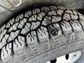 Close-up of a heavily treaded tire from a 2017 RAM Promaster showing significant wear and debris embedded in the tread pattern