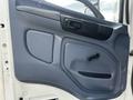 The image shows the interior driver's door panel of a 2006 Hino 268 featuring a gray plastic design with a door handle and a window crank knob
