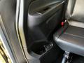 Interior view of a 2022 Mercedes-Benz Metris showing a black leather seat and a storage compartment with a cup holder