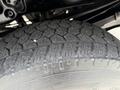 Close-up of a tire from a 2015 Ford F-350 SD showing rugged tread design and rubber texture