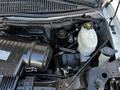 An engine compartment featuring a 2017 Chevrolet Express with visible components such as a black air intake and a transparent coolant reservoir