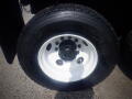 A close-up view of a black tire on a white wheel with a central hub for a 2016 International WorkStar 7500