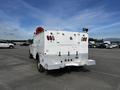 A white 2017 Ford F-350 SD truck with a service body and various mounted equipment in the bed