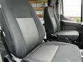 Two gray front seats of a 2023 Ford Transit van featuring fabric upholstery and adjustable headrests