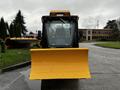 A front view of a 2015 International 3000 MT6 equipped with a large yellow snowplow blade attached to the front