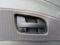 Close-up of a black door handle on the interior of a 2015 International DuraStar 4300 truck door trim