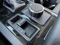 Close-up of the control panel in a 2023 Toyota Tundra featuring a dial for drive modes and buttons for shifting between 2H 4H and 4L settings