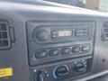 Dashboard control panel of a 2003 Ford F-450 SD featuring radio dials and climate control buttons