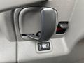 Close-up of a door handle and lock switch on the interior of a 2016 Chevrolet Express