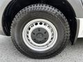 A close-up view of a wheel from a 2019 Mercedes-Benz Sprinter featuring a silver alloy rim and a Kumho tire with a rugged tread design