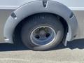 A close-up of the wheel and fender of a 2020 Chevrolet Express showing the tire and hub with visible lug nuts