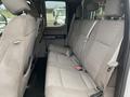 The interior of a 2018 Ford F-150 featuring a rear bench seat with gray fabric upholstery and seat belts