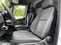 Front seats of a 2020 Mercedes-Benz Sprinter van with fabric upholstery and a simple dashboard design visible in the foreground
