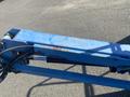 A blue Genie S-65 4X4 boom lift with visible wear and tear on the paint and hydraulic lines extending from the boom arm