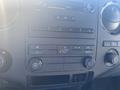 Dashboard controls of a 2014 Ford F-250 SD featuring climate control knobs audio system buttons and display screen
