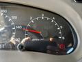 A close-up of the dashboard of a 2000 Ford Motorhome showing the speedometer and RPM gauge with the needle pointing to 140 and a warning light illuminated